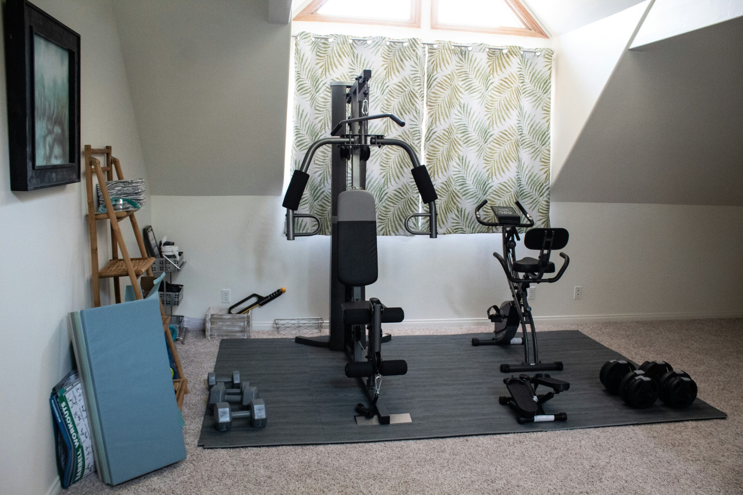 Minimalist home gym setup with workout bench and dumbbells in a modern room.